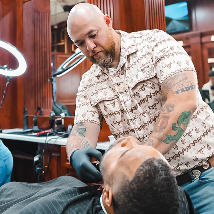 Famous Fadez barber perfecting a client’s haircut